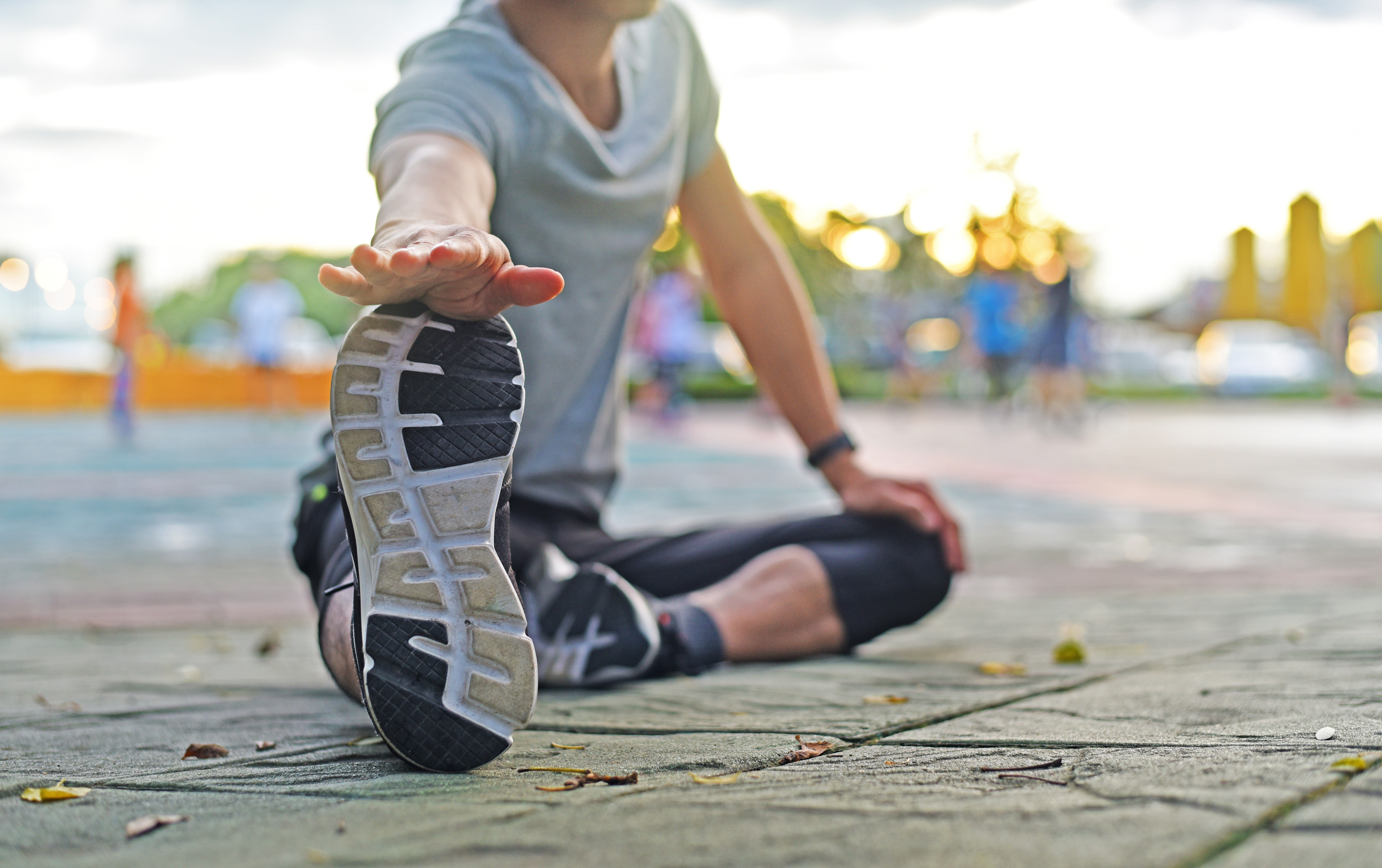 woman stretching to help avoid injury before a run