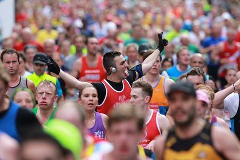 Young person listening to running music during marathon