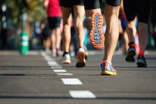 Marathon runners jogging down a road