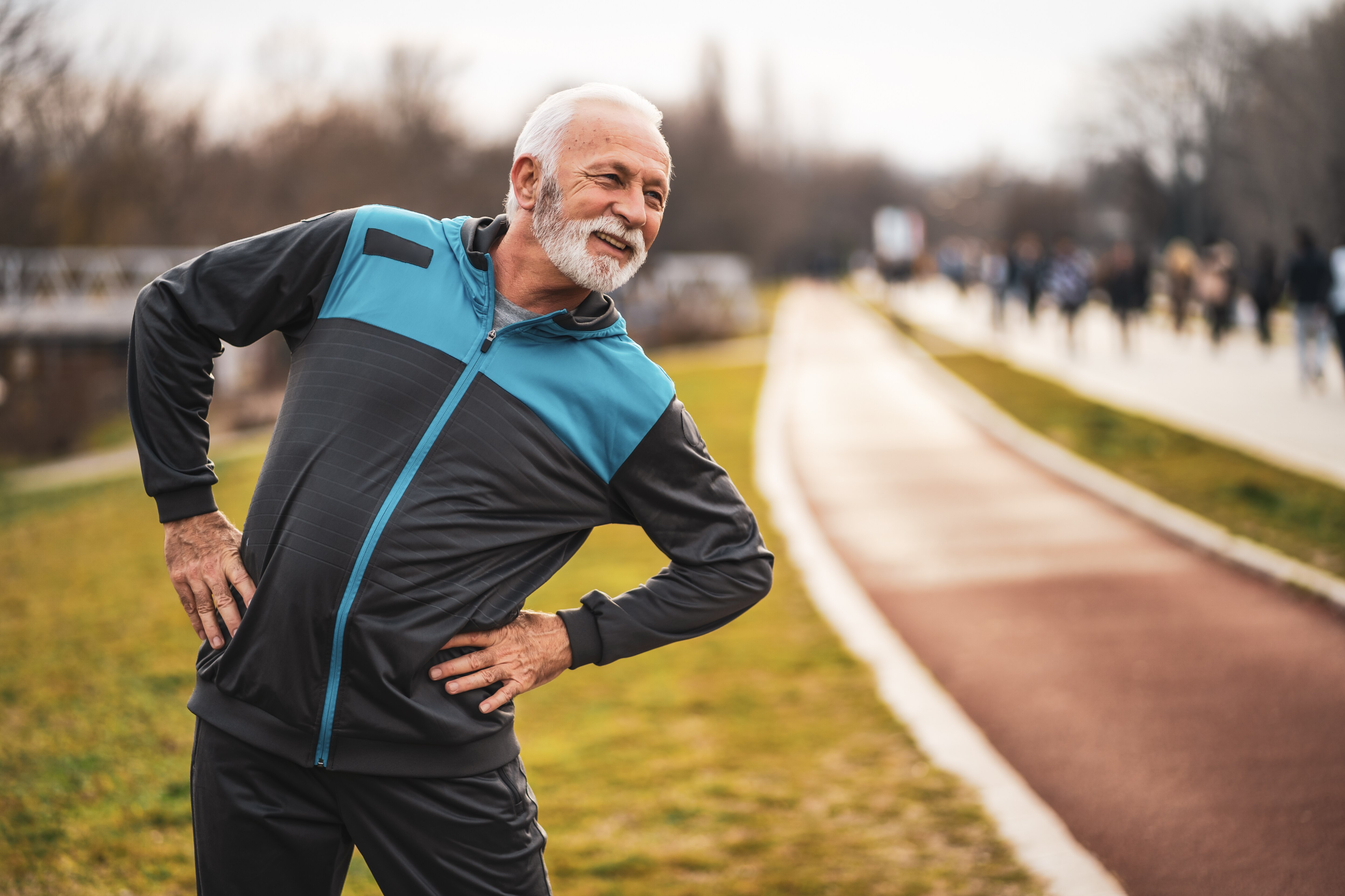 man stretching his hips after a long run