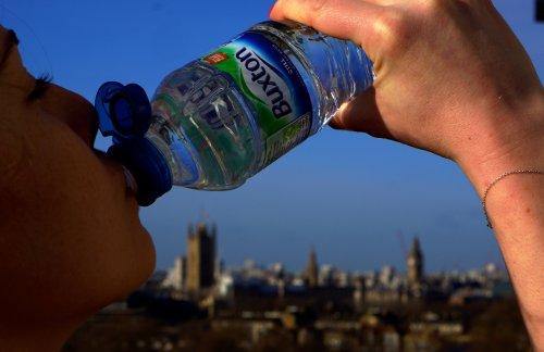 Young woman drinking Buxton Water to stay hydrated