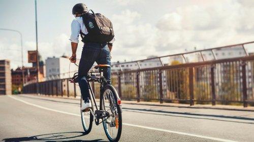 Man with a backpack riding a bike